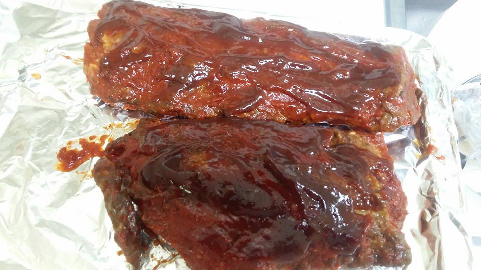 Slathering the ribs in Sweet Baby Ray's sauce...