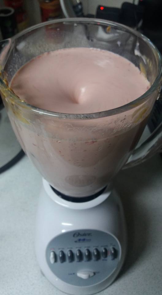 I inserted a few ice cubes (keeps things chilled, doncha ya know), banana, fresh strawberrys, ice cream, milk, and a dollop of peanut butter.  Then I liquefied it  get this...